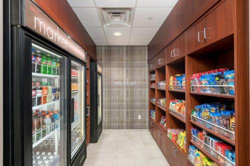 a store aisle with a drink cooler in a store at Courtyard Philadelphia Valley Forge Collegeville in Collegeville