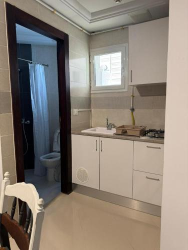 a bathroom with a sink and a toilet in it at Le style Damier in Sfax