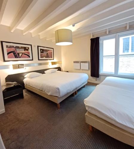 Postel nebo postele na pokoji v ubytování Hotel Koffieboontje
