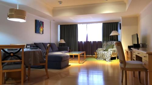 a living room with a couch and a table at Large family room near Metro Taipei station for comfort and convenience, where 5 can relax and create unforgettable moments in Taipei
