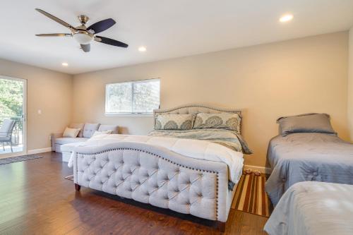a bedroom with two beds and a ceiling fan at Near Hiking and Golf Cozy Cottage in Morgan Hill! in Morgan Hill