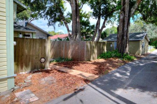 a wooden fence in front of a house at Charming Historic 2-story Carriage House located in Downtown Lakeland walking distance from FSC! in Lakeland
