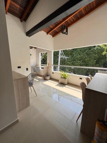 a kitchen and living room with a large window at Vida Hostel in Medellín