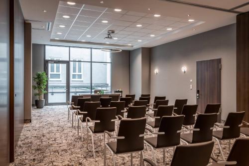 a room with rows of chairs in a room at Courtyard by Marriott Munich City Center in Munich
