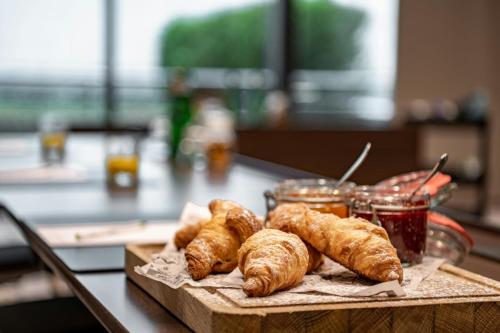 a tray of croissants and jam on a table at Courtyard by Marriott Munich City Center in Munich