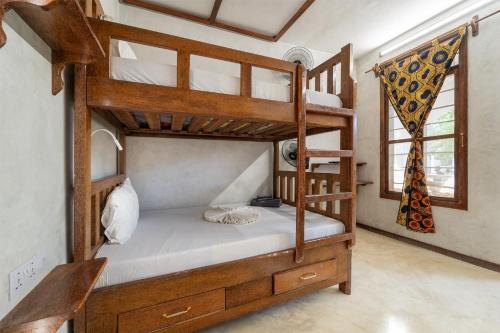 a bedroom with two bunk beds in a room at Makofi Guest House in Nungwi