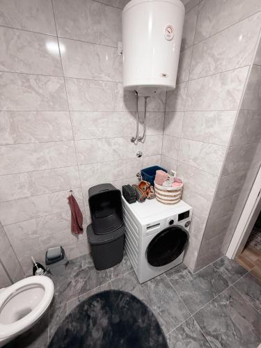 a small bathroom with a sink and a toilet at Apartment Saturday in Travnik