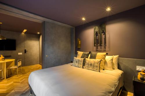 a bedroom with a large white bed with pillows at El Alfonsa in Mexico City