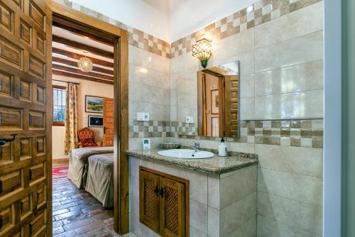a bathroom with a sink and a mirror at Villa San Nicolas - private, tranquil, relaxing.. in Ermita Nueva