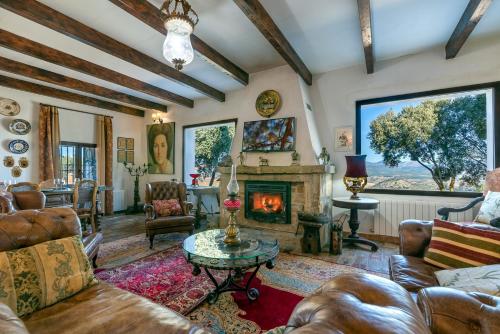 a living room filled with furniture and a fireplace at Villa San Nicolas - private, tranquil, relaxing.. in Ermita Nueva