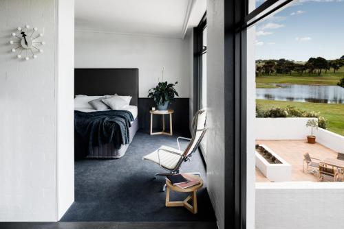 a bedroom with a bed and a balcony at Waurn Ponds Estate in Waurn Ponds