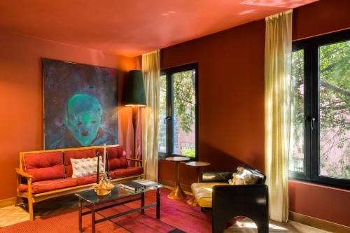 a living room with orange walls and a couch at El Alfonsa in Mexico City