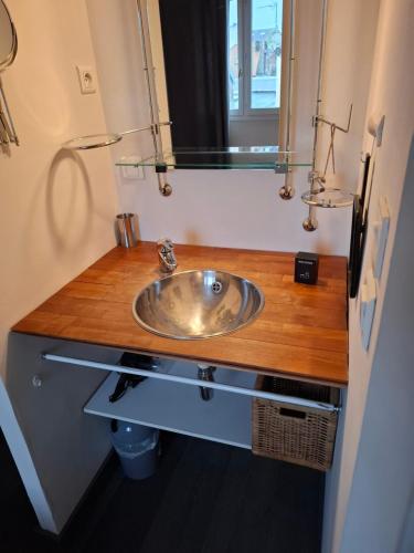 a bathroom with a sink and a mirror at Grain de sable ! terrasse en ville in Le Touquet-Paris-Plage
