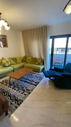a living room with a couch and a table at The Vibe in Madinaty