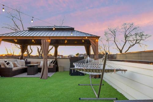 a gazebo on the roof of a house at The Lyric - New Luxury Home, Rooftop with Firepit! in Nashville