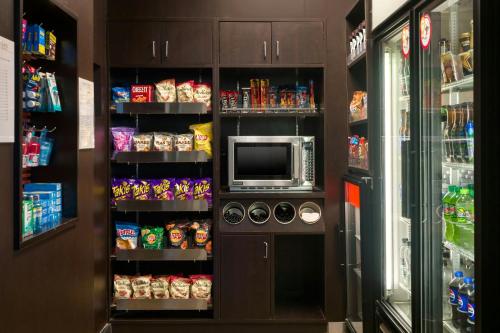 a kitchen with a microwave and a refrigerator at Courtyard by Marriott Phoenix Airport in Phoenix