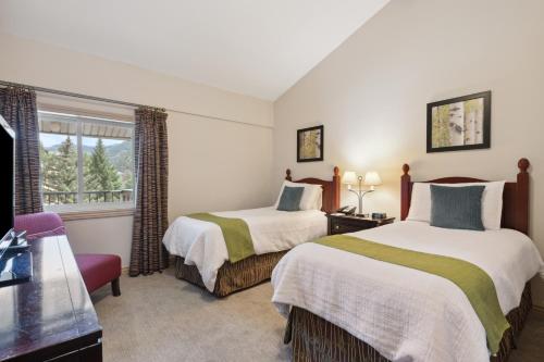 a hotel room with two beds and a window at Falcon Point in Avon