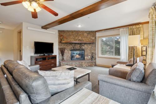 a living room with couches and a fireplace at Falcon Point in Avon