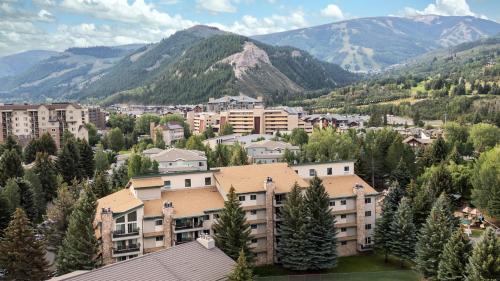 a town in the mountains with buildings and trees at Falcon Point in Avon