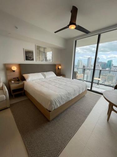 a bedroom with a large bed and a large window at NEW Luxury Bay View Downtown Studio in Miami