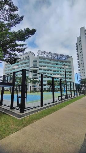 a large building with a tennis court in front of it at Le Studio Serein de Jean-Mathïs in Manila