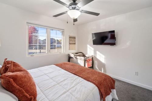 a bedroom with a bed and a ceiling fan at Dreamy Peaceful Retreat - Spa in Ankeny