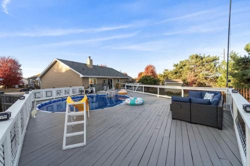 a deck with a ladder next to a swimming pool at Dreamy Peaceful Retreat - Spa in Ankeny