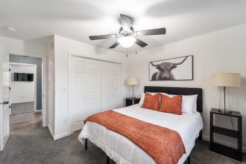 a bedroom with a bed and a ceiling fan at Dreamy Peaceful Retreat - Spa in Ankeny