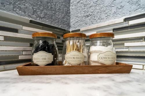two glass jars sitting on top of a shelf at Dreamy Peaceful Retreat - Spa in Ankeny