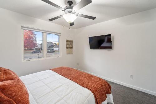 a bedroom with a bed and a ceiling fan at Dreamy Peaceful Retreat - Spa in Ankeny