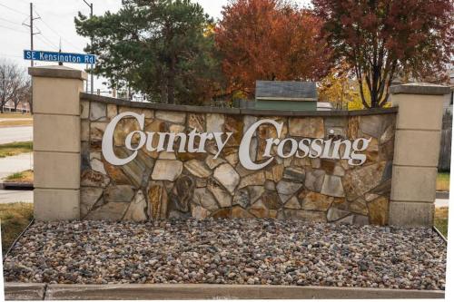 a sign for a county crossing sign on a stone wall at Dreamy Peaceful Retreat - Spa in Ankeny