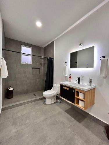 a bathroom with a toilet and a sink and a shower at CASA LUGO mx in El Porvenir