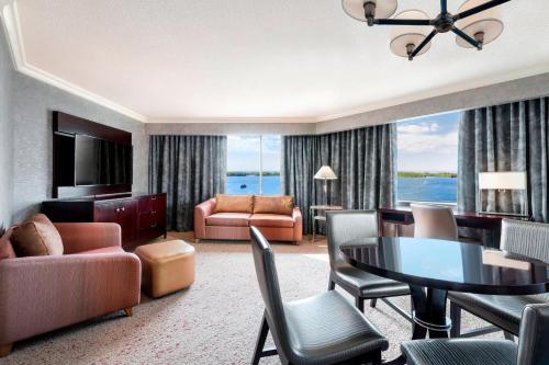 a living room with a dining table and a living room at The Westin Harbour Castle, Toronto in Toronto