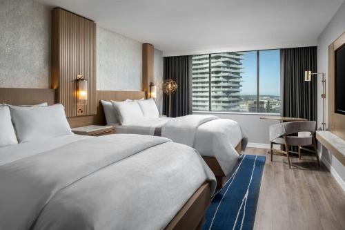 a hotel room with two beds and a window at The Westin Harbour Castle, Toronto in Toronto