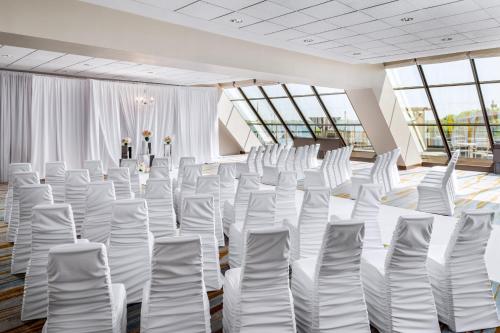 a room with white chairs in a room with windows at The Westin Harbour Castle, Toronto in Toronto