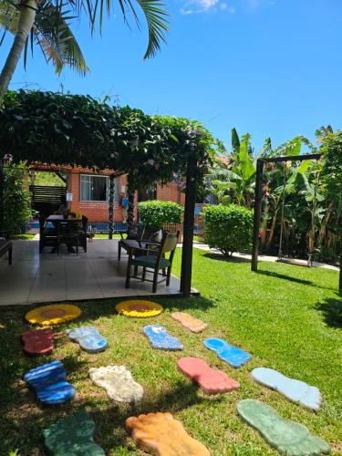 a garden with colorful rocks on the grass at Sunshine Residencial in Bombinhas