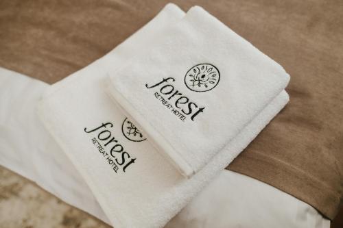 a close up of a white napkin with logos on it at Forest Retreat Center in Kyiv