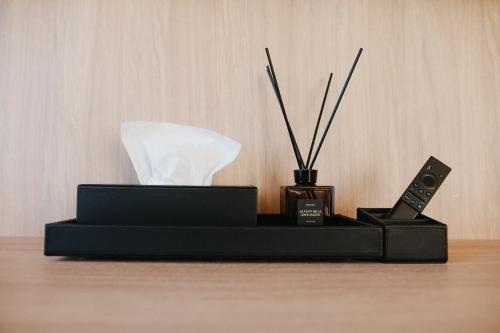 a black box with two remote controls and sticks at Forest Retreat Center in Kyiv