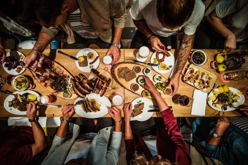 a group of people sitting around a table eating food at Le Meridien Munich in Munich
