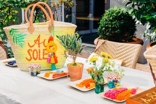 a table with vegetables and a sale sign and a purse at Le Meridien Munich in Munich