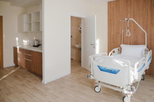 a hospital room with a bed and a kitchen at Forest Retreat Center in Kyiv