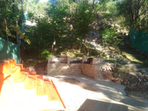 a set of stairs in a yard with trees at Campamento Monarcas in Villa Carlos Paz