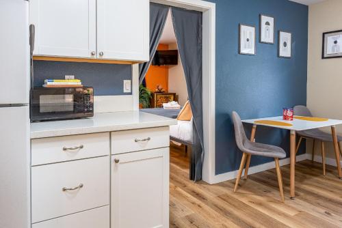 a kitchen with white cabinets and a table with a chair at Mad Men in Salem