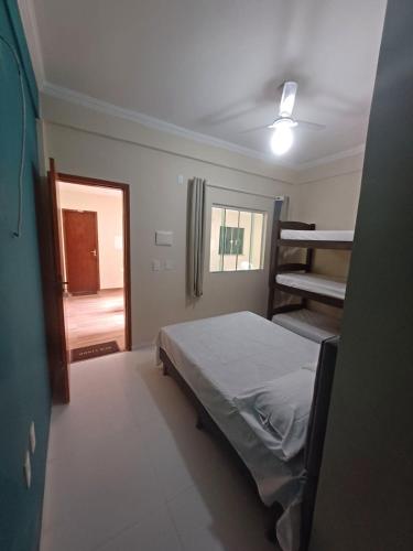 a bedroom with a bunk bed and a ladder at Pousada Estrela Mares 101 in Cabo Frio