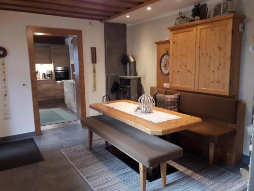 a dining room with a wooden table and a bench at Petter 3 in Tobadill