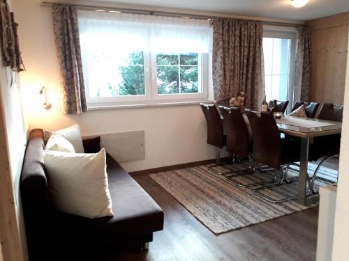 a dining room with a table and a couch at Petter 3 in Tobadill