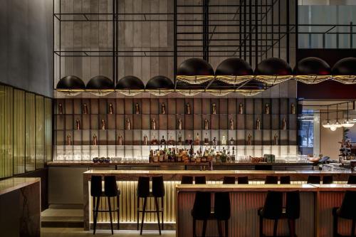 a bar with a bunch of bottles on a wall at W Montreal in Montréal