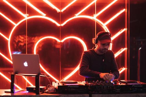 a man playing music in a room with heart lights at W Montreal in Montréal