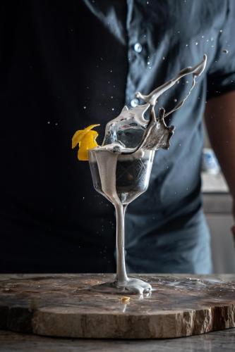 a glass of wine with a yellow flower in it at W Montreal in Montréal