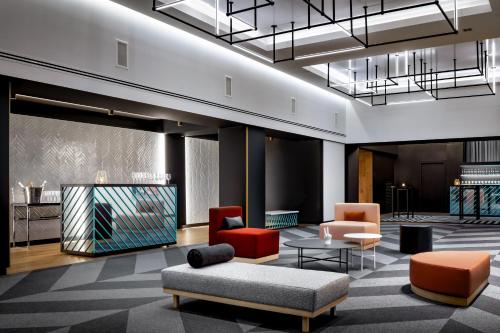 a lobby with chairs and a couch and a table at W Montreal in Montréal